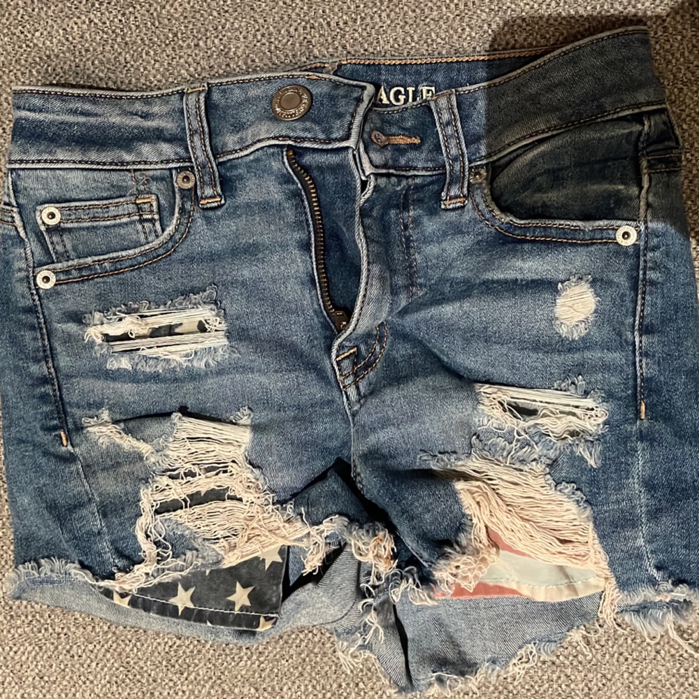 American eagle jean shorts with American flag detail on pockets.